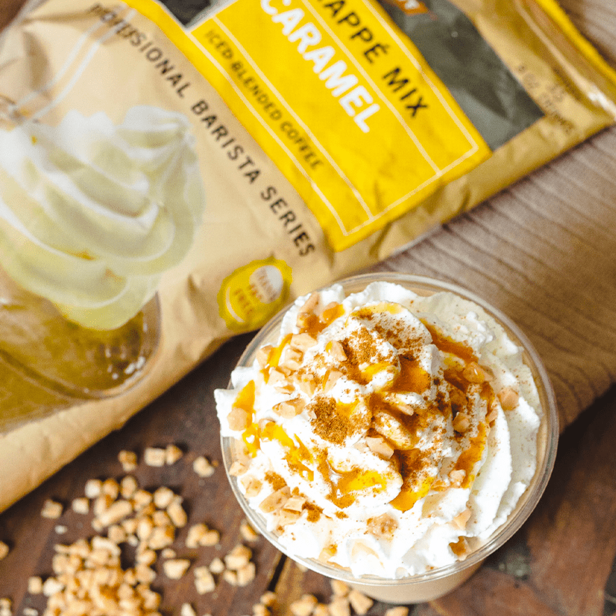 Caramel Blended ice drink with whipped cream and caramel drizzle next to a bag of Carameel Frappe Powder mix by MOCAFE.