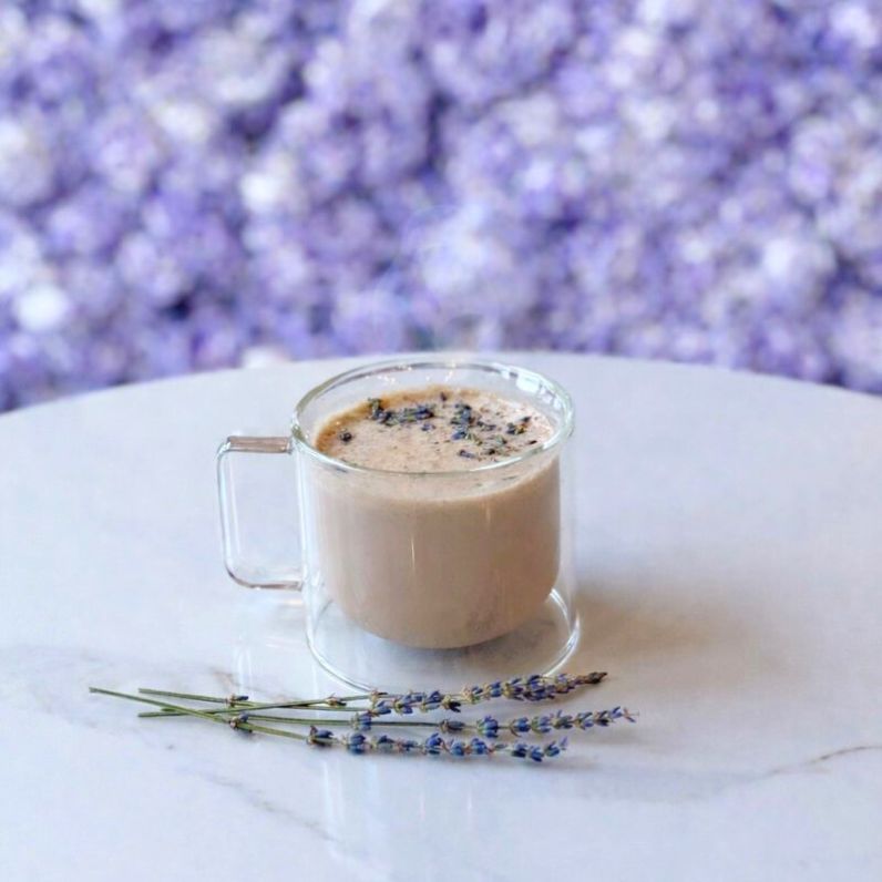 Lavender Chai Latte Recipe drink on table showing sprig of lavender flowers